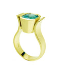 This yellow gold solitaire emerald ring for women displays the top setting and band ring profile.