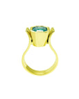 The lateral position of this 14k yellow gold emerald solitaire ring shows the bezel setting and band of the ring.