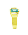 The image of this natural emerald solitaire ring for women displays the top bezel and side profile of the band.