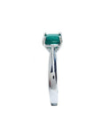 Colombian emerald solitaire silver ring with a square emerald cut, deep bluish-green gemstone in four prongs.