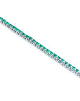 14K gold tennis bracelet with round-cut, medium deep green Colombian emeralds, prong set.