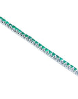 14K gold tennis bracelet with round-cut, medium deep green Colombian emeralds, prong set.