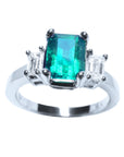 This three stone emerald engagement ring is placed on top position with both sides profila view.