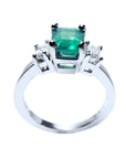 This natural emerald and side diamonds ring for women has a visible top and galley profile.