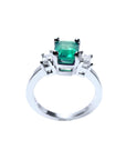 This natural emerald and side diamonds ring for women has a visible top and galley profile.