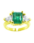 18k yellow gold ring with a natural colombian emerald and side trillion cut diamonds on sale at factory price.