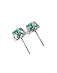 Pair of tulip design emerald stud earrings in 14K white gold with push backs.