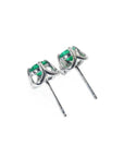 Pair of tulip design emerald stud earrings in 14K white gold with push backs.