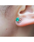 Tulip emerald stud earrings with round cut natural Muzo Colombian emeralds in 14K white gold.
