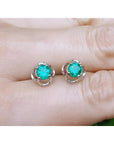 Tulip emerald stud earrings 1.03 ct. with round green emeralds in 14K white gold.