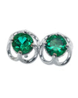 Pair of emerald tulip emerald stud earrings on a front position top view