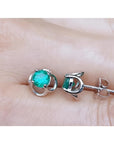 Tulip emerald stud earrings with round cut green emeralds set in 14K white gold.
