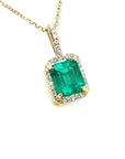 Gold necklace with a natural emerald pendant on a right-side profile view