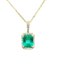 Emerald-cut emerald pendant with diamond halo on a 14k yellow gold chain.
