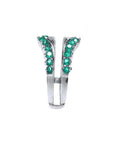 A deep green Colombian emeralds enhancer ring displaying its side profile