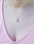 A Colombian emerald necklace enhancer on a person's neck.