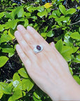Men's Ethiopian black opal silver ring with fiery red, green, and blue flashes, oval cabochon.