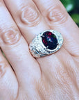 Men's sterling silver ring with a fiery red Ethiopian black opal, oval cabochon, and engraved band.