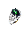 Silver ring with a natural black opal on a tilted position, topside and lateral side profile view.