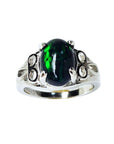 The topside view of a silver ring with a black Ethiopian opal on a white background