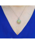 Ethiopian Welo opal and diamond pendant in 14K white gold, worn on a woman's neck.