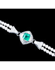 18K white gold emerald and pearl bracelet with a central bezel-set emerald, diamond accents.