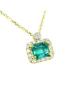 Colombian emerald necklace encircled in a halo of natural diamonds, crafted in 14k yellow gold