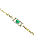 14K yellow gold bracelet with a central emerald-cut Colombian emerald and diamond accents.