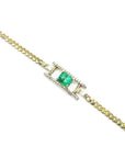 14K yellow gold bracelet with a central emerald-cut Colombian emerald and diamond accents.