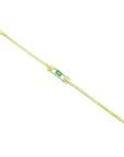 14K yellow gold bracelet with a rectangular Colombian emerald surrounded by diamonds.