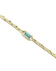 14K yellow gold bracelet with a vibrant bluish-green emerald-cut emerald and diamond accents.