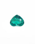 1.14 carat heart-cut Colombian emerald with a rich bluish-green color on a white background.