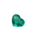 Heart cut loose natural colombian emerald front left side exposing table and crown