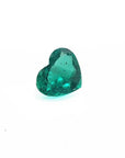 1.14 carat heart cut Colombian emerald with a rich bluish-green color on a white background.