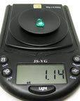1.14 carat heart-cut Colombian emerald on a black digital jewelry scale.