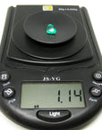 1.14 carat heart-cut Colombian emerald on a black digital jewelry scale.