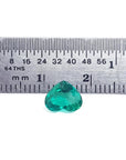 1.14 carat heart-cut Colombian emerald, rich bluish-green, shown with a ruler for scale.