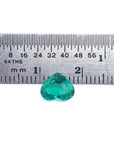 1.14 carat heart-cut Colombian emerald, rich bluish-green, shown with a ruler for scale.