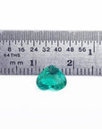 1.14 carat heart-cut Colombian emerald, rich bluish-green, shown with a ruler for scale.