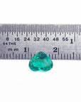 1.14 carat heart-cut Colombian emerald, rich bluish-green, shown with a ruler for scale.