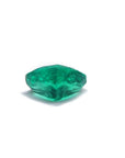 1.14 carat heart cut Colombian emerald with a rich bluish-green color on a white background.