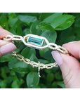 14K yellow gold bracelet with a vibrant emerald-cut Colombian emerald and accent diamonds.