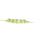Sparkling 14K gold necklace with five round-cut medium light green Colombian emeralds.