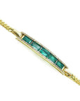 14K yellow gold bracelet with baguette-cut Colombian emeralds and diamond accents.
