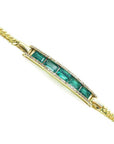 14K yellow gold bracelet with baguette-cut Colombian emeralds and diamond accents.