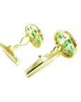 Men's gold cufflinks with natural emeralds and diamonds in a round setting.