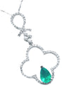 White gold necklace with an emerald teardrop pendant in four leaf clover pendant design with diamonds.