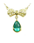 Pear shaped natural emerald bowtie necklace from Muzo mine in Colombia, yellow diamonds pave set in 18k yellow gold