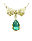 Pear shaped natural emerald bowtie necklace from Muzo mine in Colombia, yellow diamonds pave set in 18k yellow gold