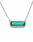 Front view of a natural emerald necklace white gold with a halo diamond pendant on a white background